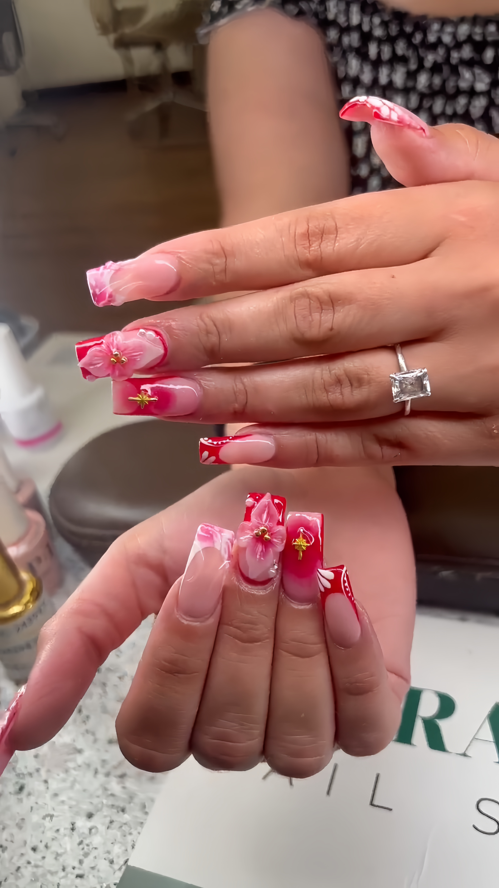 Red and pink 3D floral nail art with gold stars