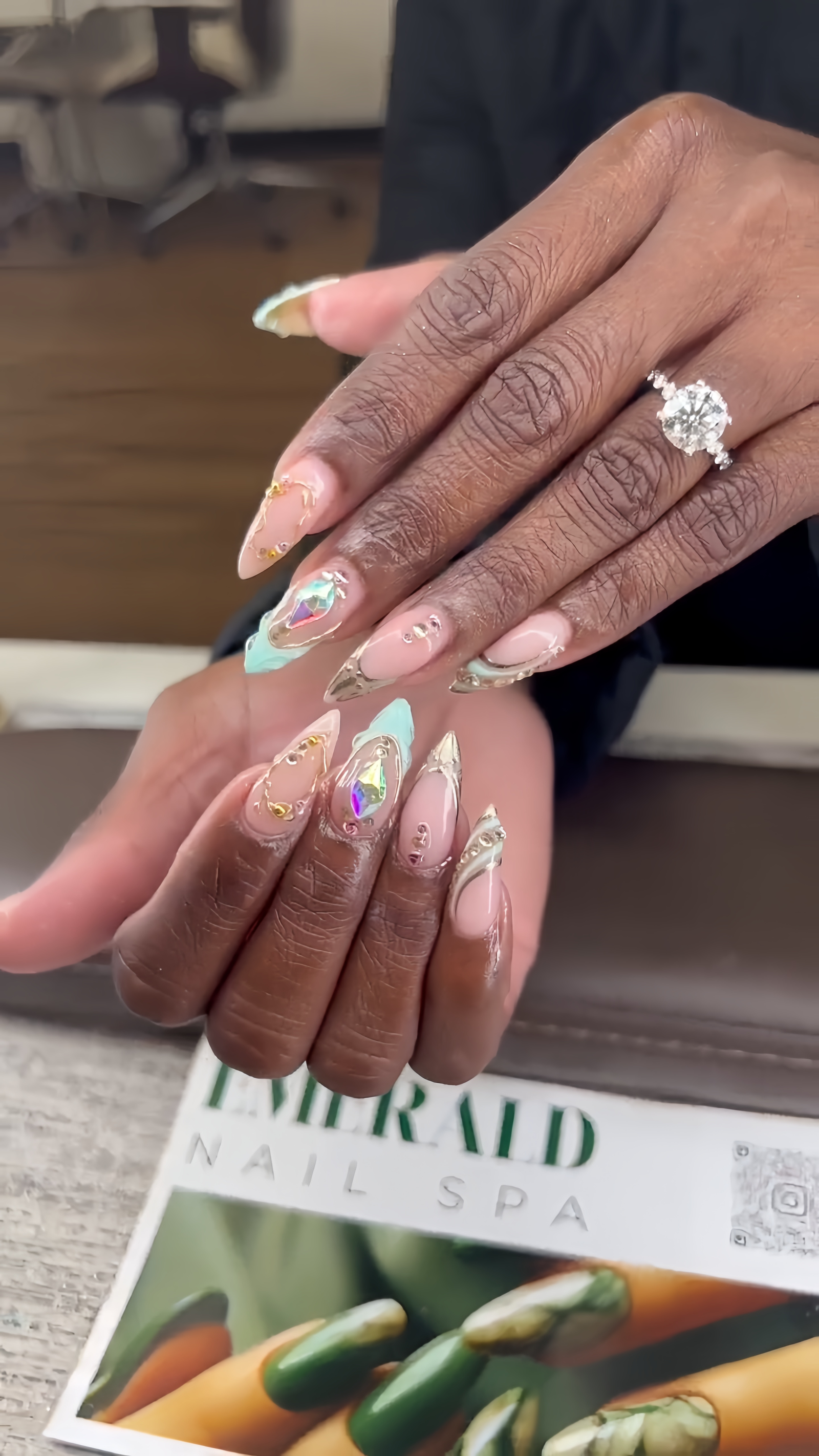Elegant iridescent gem nails with gold detailing at Emerald Nail Spa